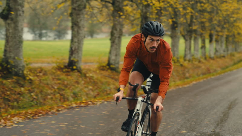 Florian cycling down an autumn avenue