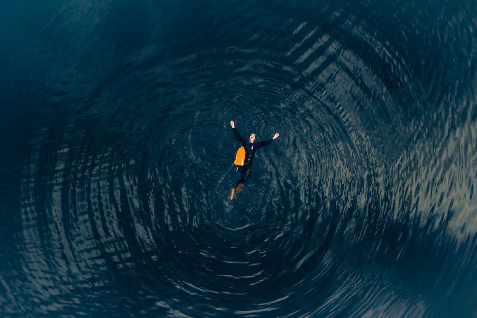 Aerial view of Florian swimming in dark open water