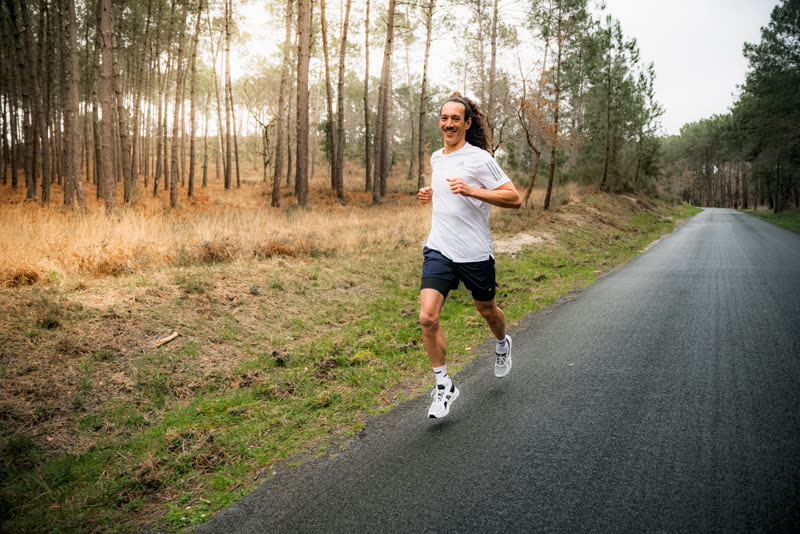Florian running along a sunny forest road